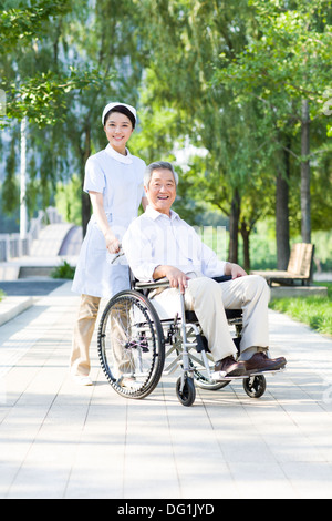 Nurse with wheelchair bound patient Stock Photo