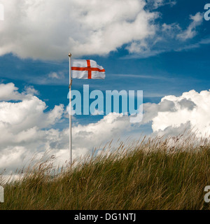 Flag of St George against blue sky with white clouds (square format). Stock Photo