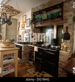 Black Aga In Brick Fireplace In Cottage Kitchen Stock Photo