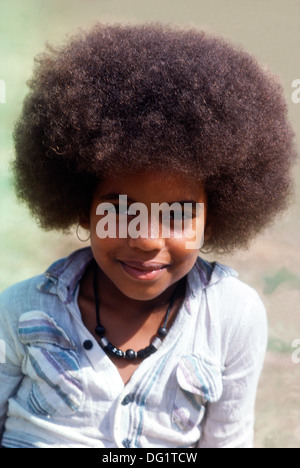 Beautiful black girl African American child smiling with an Afro hair style 1970s seventies fashion referred to as a 'natural' in Los Angeles California US USA 1972 1970s  KATHY DEWITT Stock Photo