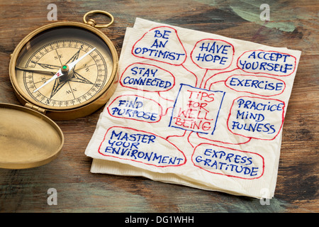 tips for well-being - a napkin doodle with a vintage brass compass Stock Photo