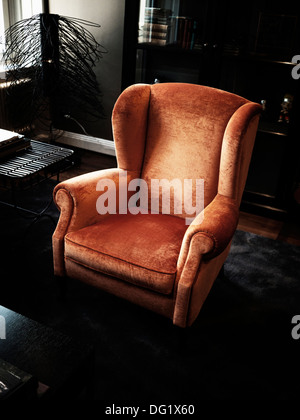 Upholstered Wing Chair in Living Room Stock Photo