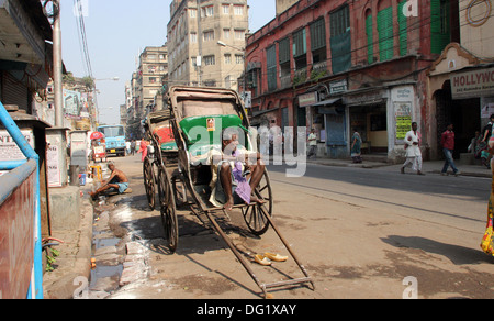 Rickshaw man waits for the customers on the streets on November 28, 2012 in Kolkata, India. Stock Photo