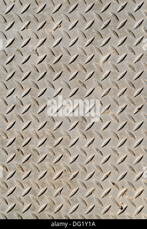 Cross-hatched metal anti-skid surface background pattern. Stock Photo