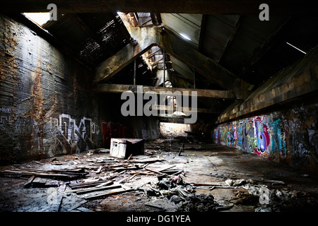 Large Abandoned Room Covered in Graffiti and Rubble Stock Photo