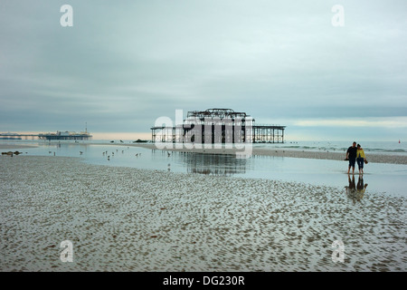 Low tide exposes sand to the piers in Brighton