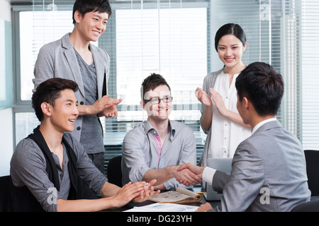 Business persons shaking hands for cooperation Stock Photo