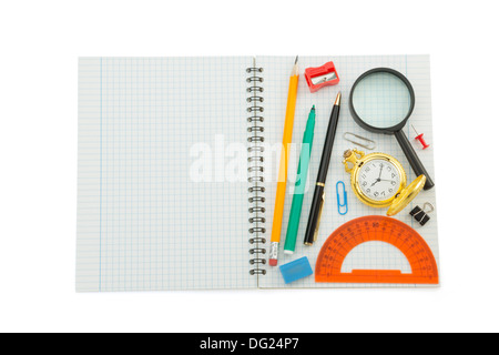 school supplies on checked notebook isolated at white background Stock Photo