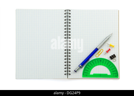 school supplies on checked notebook isolated at white background Stock Photo