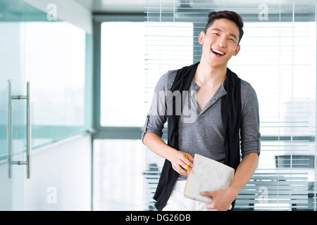Young businesswoman with laptop in the office Stock Photo
