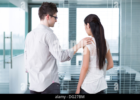 Businessman consoling his workmate Stock Photo