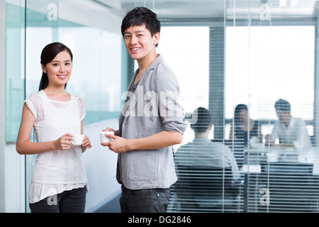 Happy office workers taking a coffee break Stock Photo