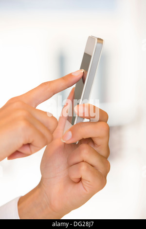Female cell phone message sms indoor Stock Photo