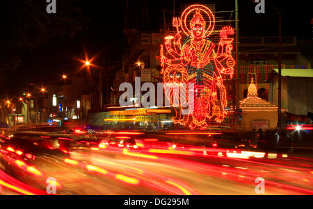 Bangalore, India. 12th Oct, 2013. Large lit-up art form of Hindu godess Durga during rush hour traffic in Bangalore, India. The festival of Durga pooja lasts for a week starting October 9th. © The Right Vibes/Alamy Live News Stock Photo