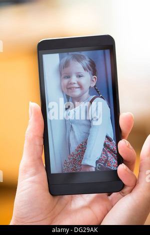 Woman looking picture on smartphone Stock Photo
