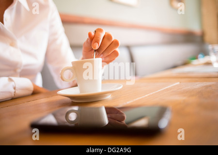 Female restaurant hand coffee table mobile phone Stock Photo