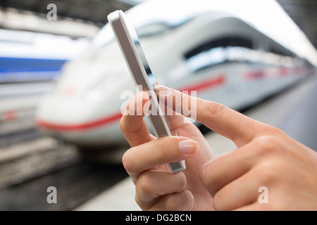 Female mobile phone tgv message sms Stock Photo