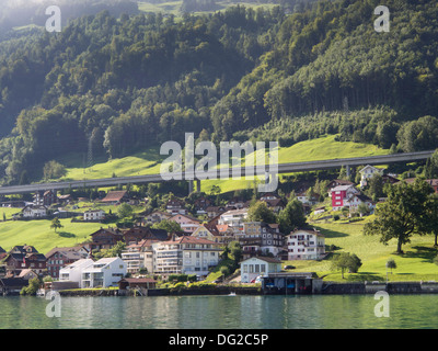 Boat trip on Lake Lucerne Switzerland, approaching Beckenried, Erlibach, the motorway and mountainside behind Stock Photo