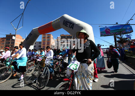 El Alto, Bolivia. 12th Oct, 2013.  Competitors line up before the start of a Cholitas Bicycle Race for indigenous Aymara women. The race is held at an altitude of just over 4,000m along main roads in the city of El Alto (above the capital, La Paz) for Bolivian Womens Day, which was yesterday Friday October 11th. Credit:  James Brunker / Alamy Live News Stock Photo