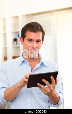 Male working on digital tablet at home Stock Photo