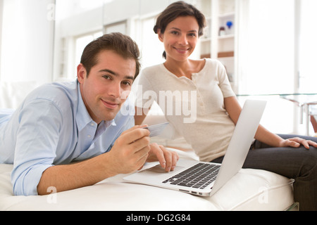 Woman man laptop indoor living room computer internet sofa Stock Photo