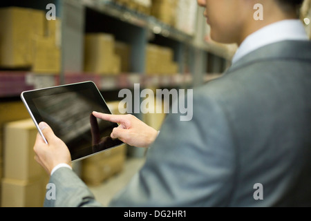 Businessman using digital tablet in warehouse Stock Photo