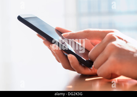 Female holding mobile phone. indoor.fingers
