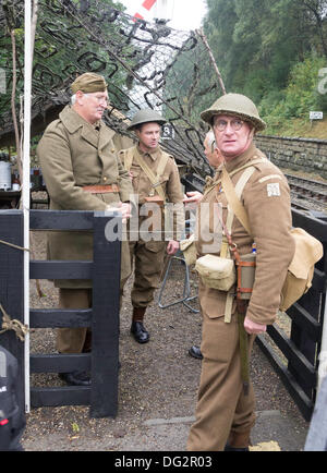 Three men dressed as WW2 Home Guard soldiers, guarding Goathland Station on The North Yorkshire Moors Railway during the Railway in Wartime week-end October 2013 Stock Photo