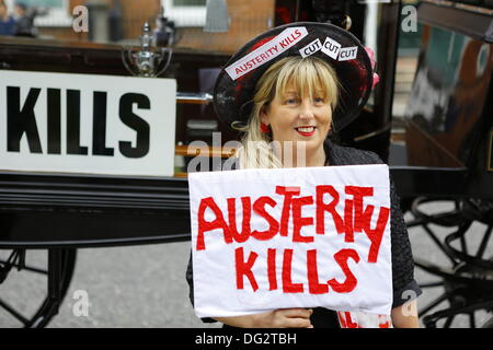 Dublin, Ireland. 12th October 2013. A member of the Spectacle of Defiance & Hope holds a sign that reads 'Austerity Kills'. Unions called for a protest march through Dublin, ahead of the announcing of the 2014 budget next week. They protested against cuts in Social Welfare, Health and Education and for an utilisation of alternative revenue sources by the government. © Michael Debets/Alamy Live News Stock Photo