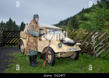 Bob Fleming with MG 34 machine gun & VW type 82 'Kübelwagen' at the ‘Railway in Wartime’  The Volkswagen Kübelwagen, 'Tub' car, previously mostly used for rail, industrial or agricultural hopper cars) was a light military vehicle designed by Ferdinand Porsche and built by Volkswagen during World War II for use by the German military (both Wehrmacht and Waffen-SS). Based heavily on the Volkswagen Beetle, it was prototyped as the Type 62, but eventually became known internally as the Type 82. Stock Photo