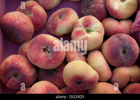 Saturn peaches or Donut (Doughnut) peaches, Prunus persica var. platycarpa, at a market stall, Hanover, Lower Saxony, Germany Stock Photo