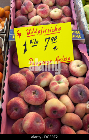 Saturn peaches or Donut (Doughnut) peaches, Prunus persica var. platycarpa, at a market stall, Hanover, Lower Saxony, Germany Stock Photo