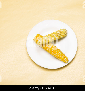 Fresh Cooked Corn on the Cob on White Plate, High Angle View Stock Photo