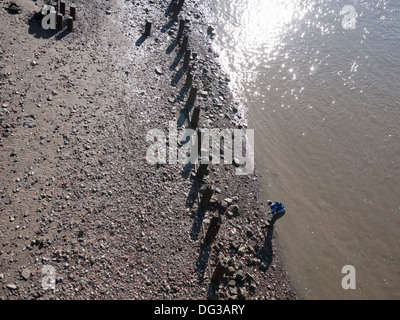 Mudlark, person searching for artifacts washed up on the banks of the River Thames in central London Stock Photo