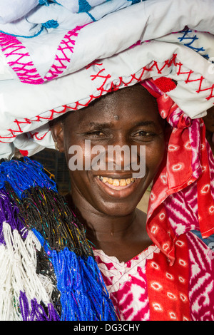 Senegal, Touba. Woman Selling Cloth in the Market. Stock Photo