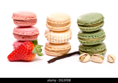 Three stacks of french macarons with flavour of strawberry, vanilla and pistachios Stock Photo