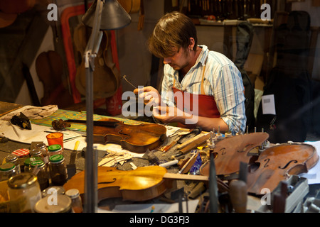 A Violin Maker and restorer in his workshop Stock Photo