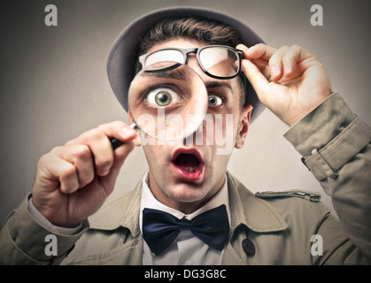 Young detective using a magnifying glass Stock Photo