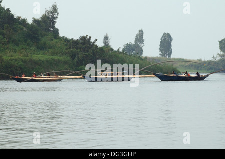 Flotilla of fishing boats working together with extended poles trawling the nets on Lake Kivu in Rwanda Central Africa Stock Photo