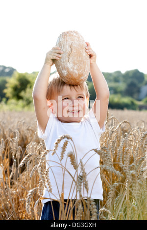 little boy with the bread over your head in the mature grain Stock Photo