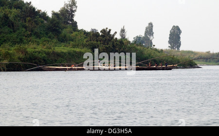 Flotilla of fishing boats working together with extended poles trawling the nets on Lake Kivu in Rwanda Central Africa Stock Photo