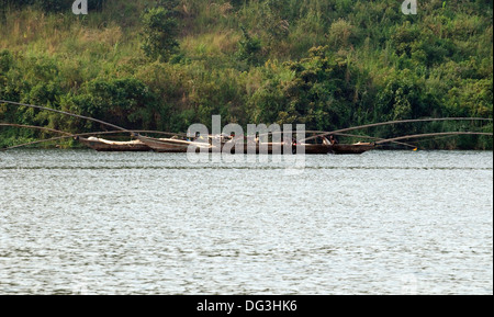 Flotilla of fishing boats working together with extended poles trawling the nets on Lake Kivu in Rwanda Central Africa Stock Photo