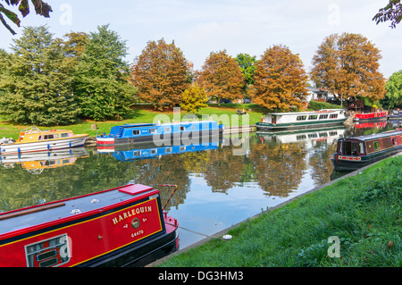 Canal boats and autumn colours reflected in the River Cam in Cambridge, England, UK