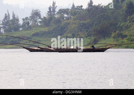 Flotilla of fishing boats working together with extended poles trawling the nets on Lake Kivu in Rwanda Central Africa Stock Photo