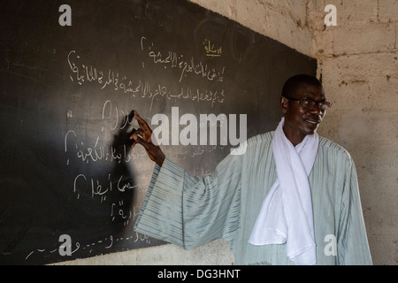 Senegal, Touba. Teacher Lecturing in Arabic to Students at Al-Azhar Madrasa, a School for Islamic Studies. Stock Photo