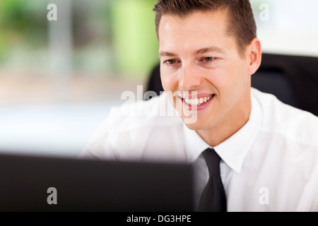 handsome businessman looking at computer screen at workplace Stock Photo