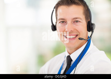 successful male call center employee wearing a headset Stock Photo
