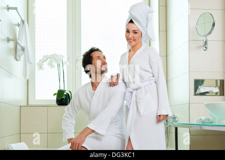 Young couple in bathroom of hotel making a bubble bath Stock Photo