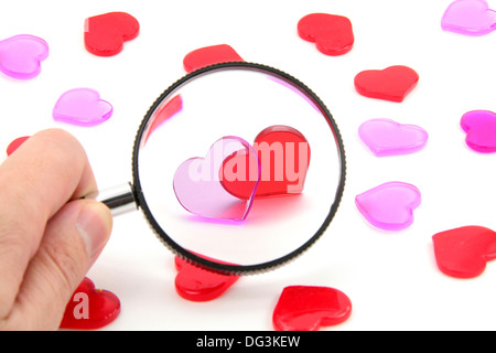 red heart and magnifier, love concept, with white background Stock Photo