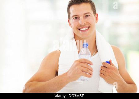 attractive fitness man drinking water after working out Stock Photo